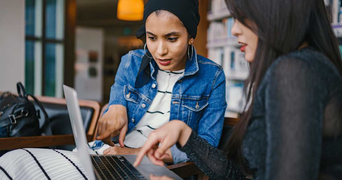 women-discussing-ecommerce-business-over-laptop